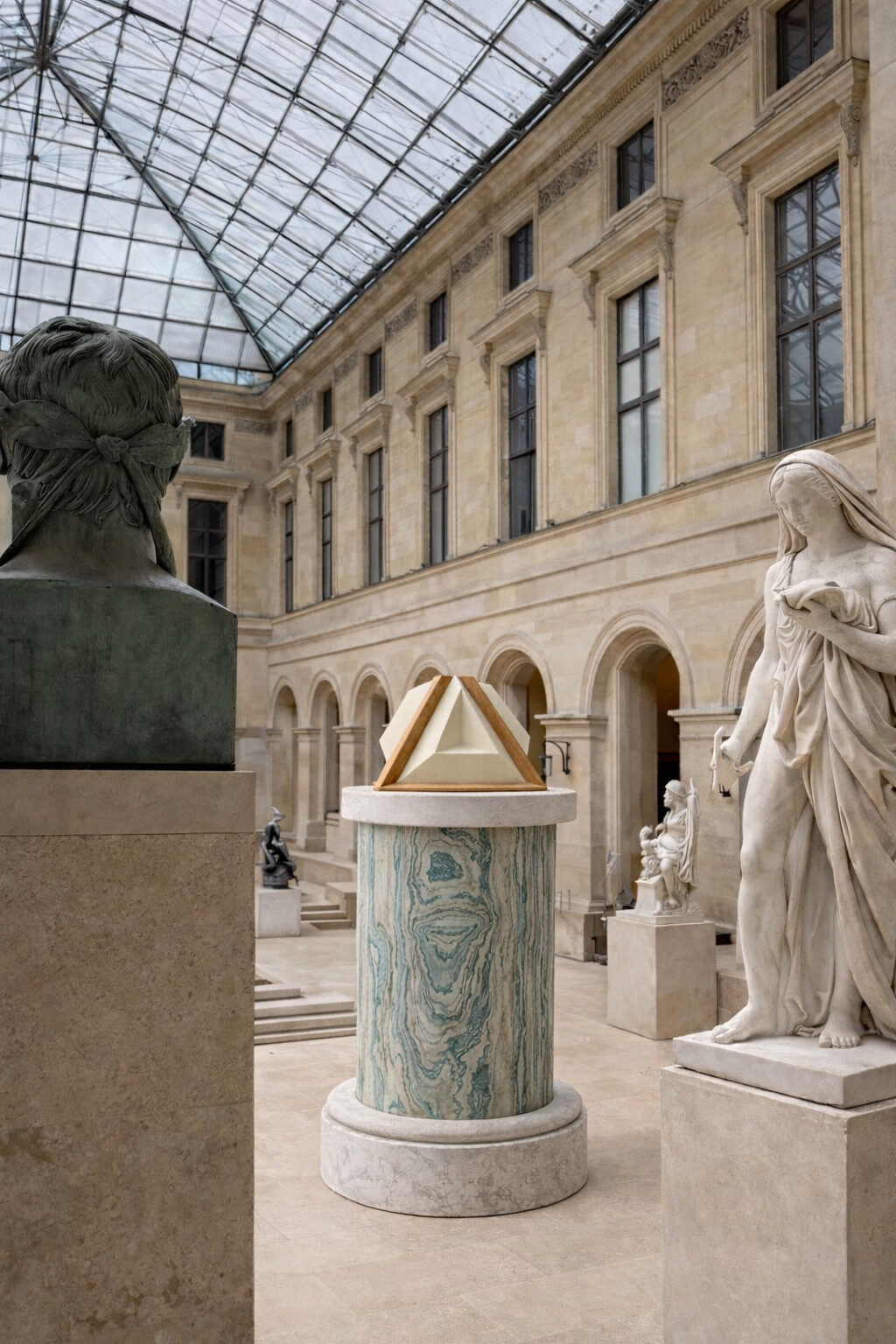 The loudspeaker on a marble column in a classical sculpture court